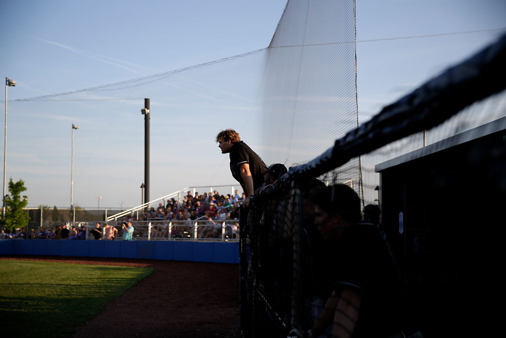 Junior Will Norris cheers on his teammate from the Rock Bridge dugout